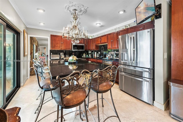 kitchen featuring pendant lighting, decorative backsplash, ornamental molding, stainless steel appliances, and a chandelier