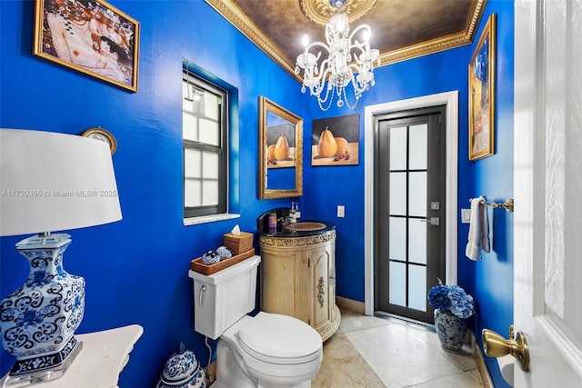 bathroom with sink, an inviting chandelier, tile patterned flooring, toilet, and ornamental molding