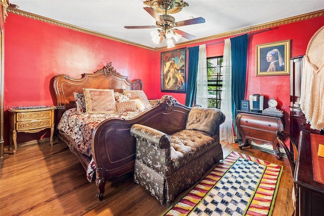 bedroom featuring wood-type flooring, ceiling fan, and ornamental molding