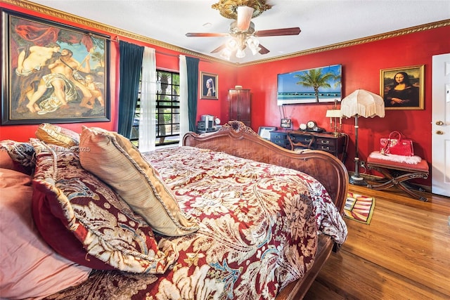 bedroom featuring hardwood / wood-style flooring, ceiling fan, access to exterior, and crown molding