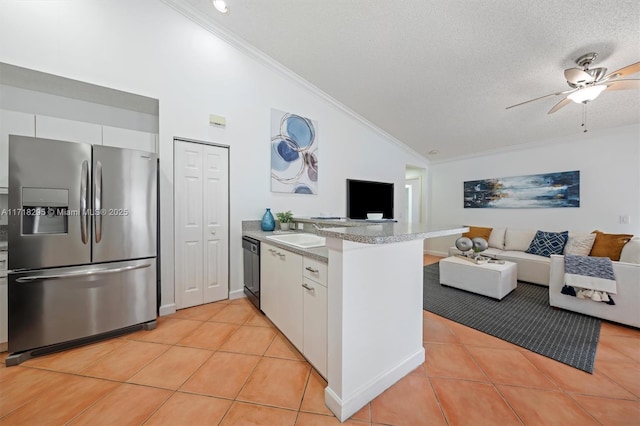 kitchen with lofted ceiling, white cabinets, stainless steel refrigerator with ice dispenser, a textured ceiling, and kitchen peninsula