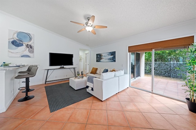 tiled living room featuring lofted ceiling, a textured ceiling, and ornamental molding