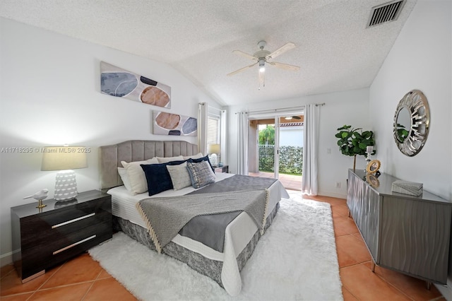 bedroom featuring ceiling fan, light tile patterned flooring, access to exterior, and lofted ceiling