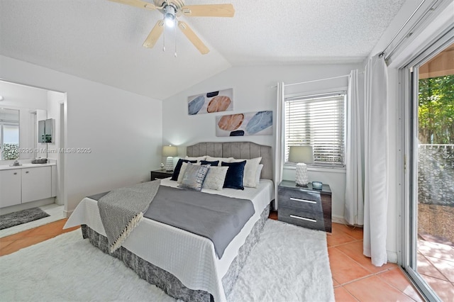 tiled bedroom with ensuite bath, ceiling fan, a textured ceiling, lofted ceiling, and access to outside