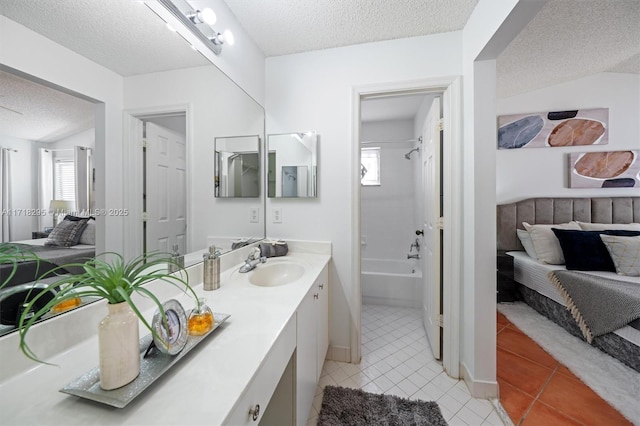 bathroom featuring tile patterned flooring, vanity, shower / bath combination, and a textured ceiling