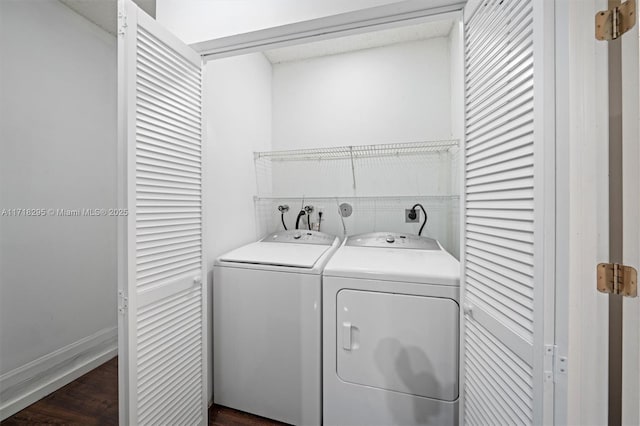 laundry room featuring washer and clothes dryer and dark wood-type flooring