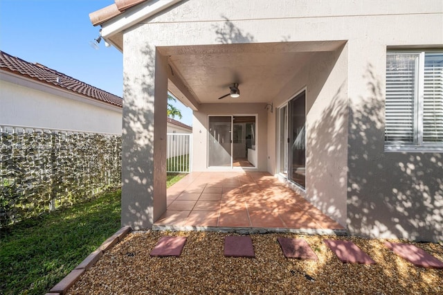 exterior space featuring ceiling fan