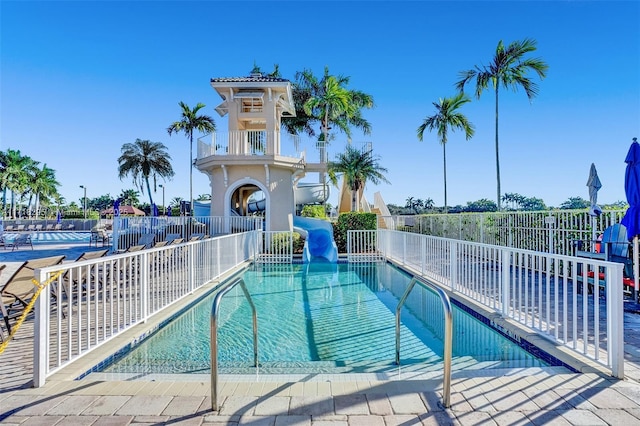 view of swimming pool with a water slide