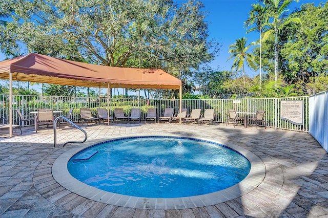 view of swimming pool with a gazebo and a patio