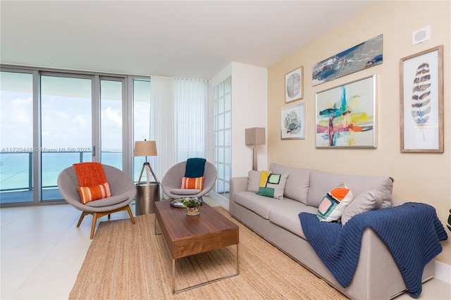 tiled living room with a water view and a wall of windows