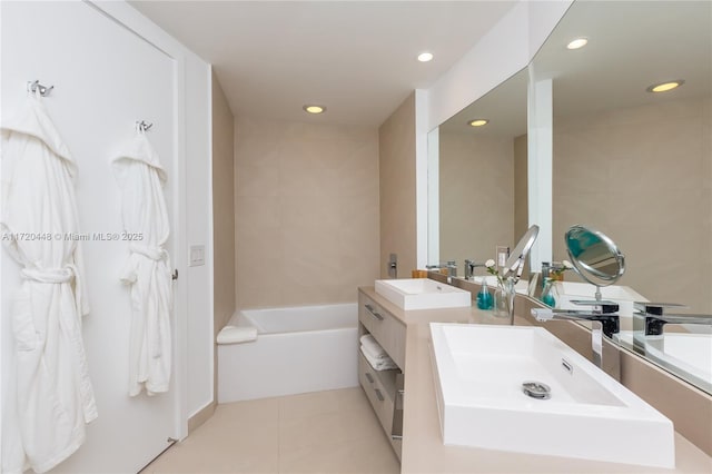 bathroom featuring tile patterned floors, vanity, and a bathtub