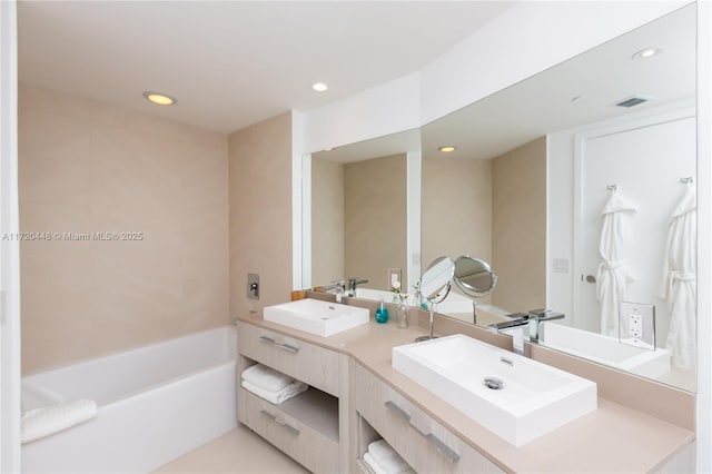 bathroom with a tub to relax in and vanity