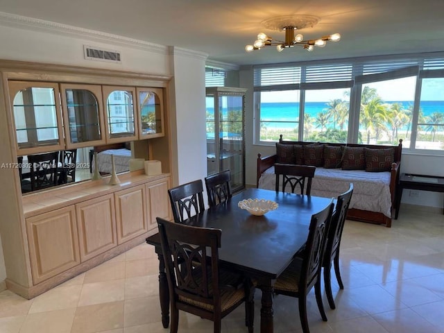 tiled dining area with crown molding, a wealth of natural light, and a chandelier