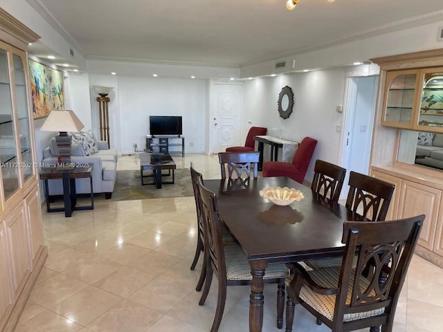 tiled dining room with crown molding