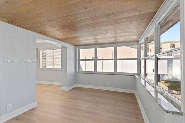 unfurnished sunroom with wood ceiling and vaulted ceiling