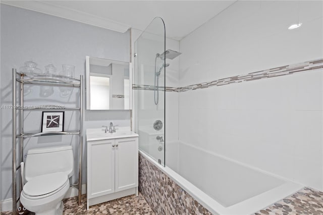 full bathroom featuring vanity, crown molding, tiled shower / bath, and toilet