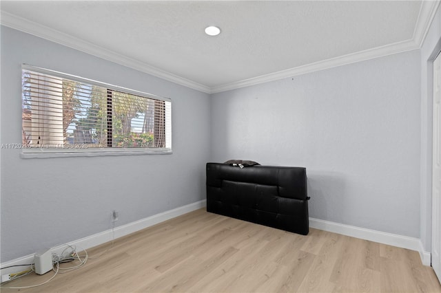 sitting room featuring ornamental molding and light hardwood / wood-style flooring