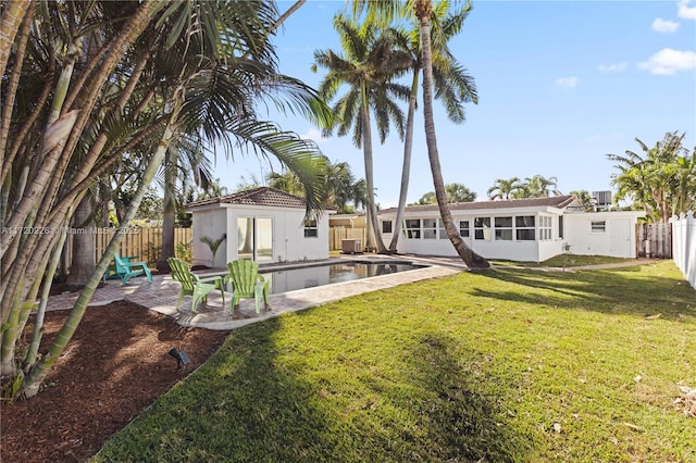 view of yard featuring a patio area and a fenced in pool