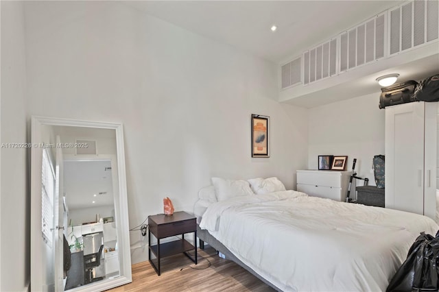 bedroom with hardwood / wood-style flooring