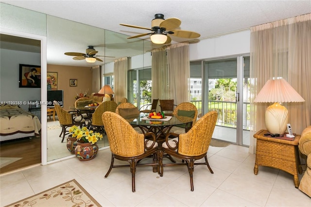 tiled dining room with ceiling fan and a textured ceiling