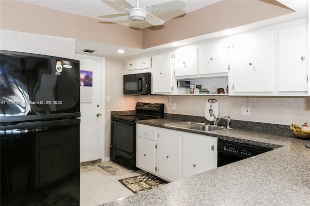 kitchen featuring light tile patterned floors, sink, white cabinetry, and black appliances