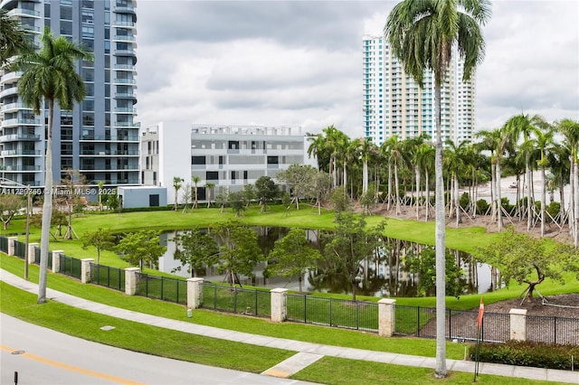 surrounding community featuring a lawn and a water view