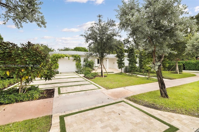 mediterranean / spanish house featuring a front lawn and a garage