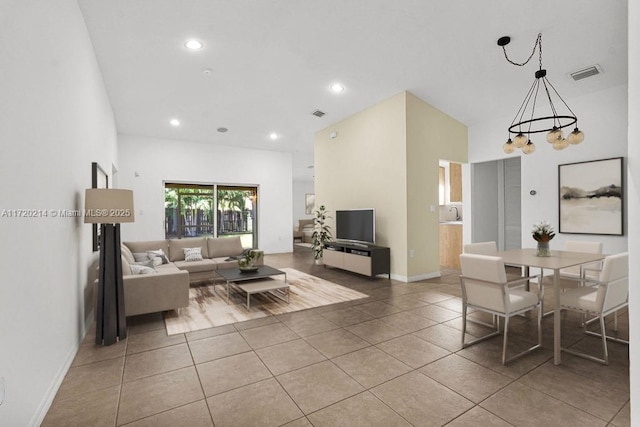 living room with light tile patterned floors and a chandelier