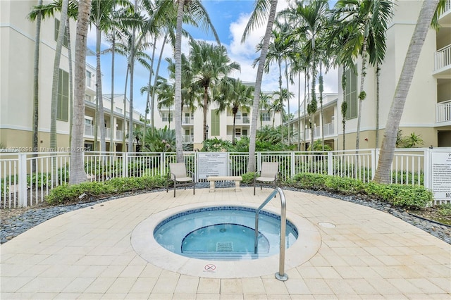 view of swimming pool featuring a patio and a hot tub