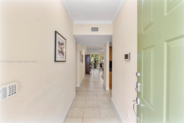 hallway featuring light tile patterned floors and ornamental molding