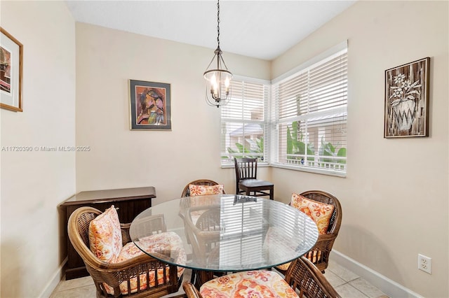 tiled dining space with a chandelier