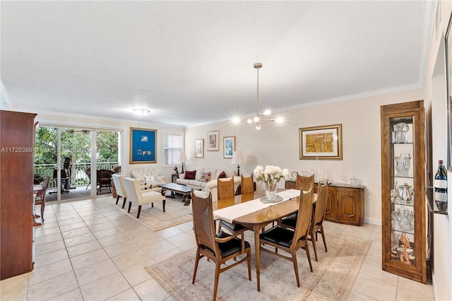 tiled dining area featuring a chandelier, a textured ceiling, and ornamental molding