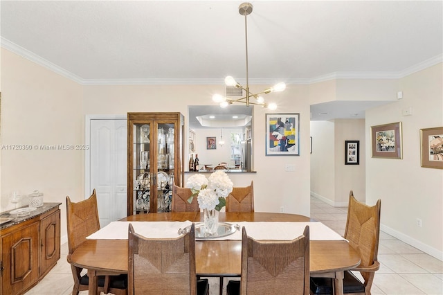 dining area featuring light tile patterned floors, ornamental molding, and an inviting chandelier