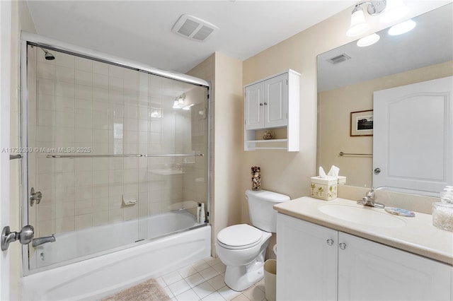 full bathroom with toilet, vanity, tile patterned floors, and enclosed tub / shower combo