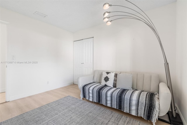 bedroom featuring a closet and light hardwood / wood-style flooring