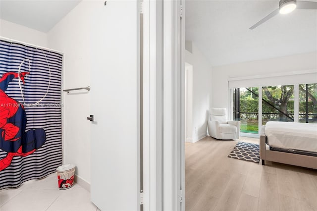 bedroom with ceiling fan, light hardwood / wood-style flooring, and vaulted ceiling