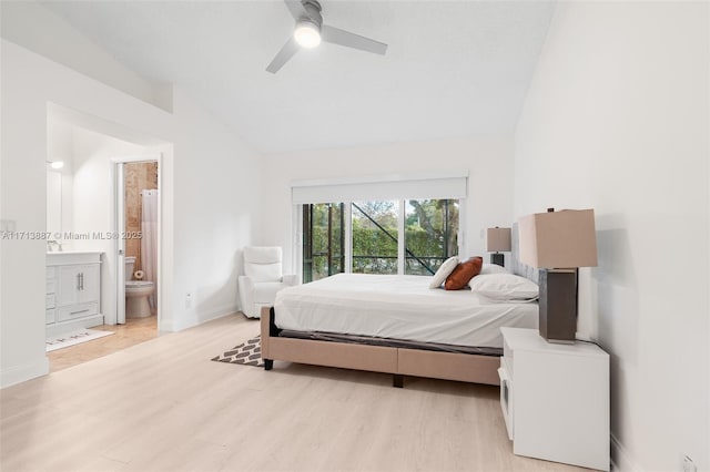 bedroom with vaulted ceiling, light hardwood / wood-style flooring, ensuite bath, and ceiling fan