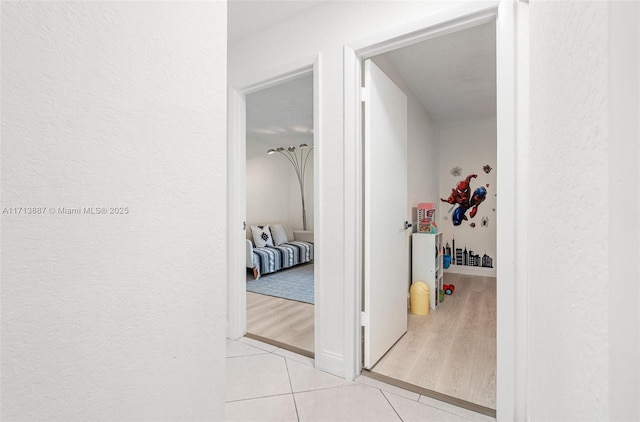 corridor featuring light tile patterned floors