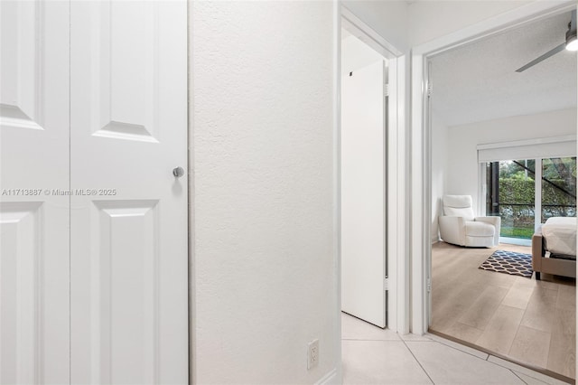 corridor featuring light tile patterned floors