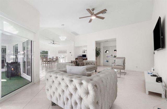 tiled living room featuring ceiling fan and vaulted ceiling