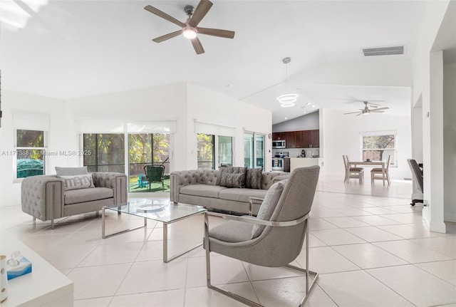 tiled living room featuring vaulted ceiling and ceiling fan