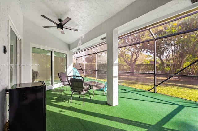 sunroom featuring ceiling fan and vaulted ceiling