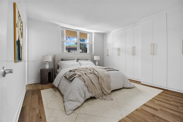 bedroom with hardwood / wood-style flooring