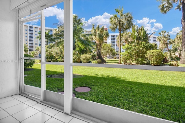 doorway to outside with light tile patterned flooring