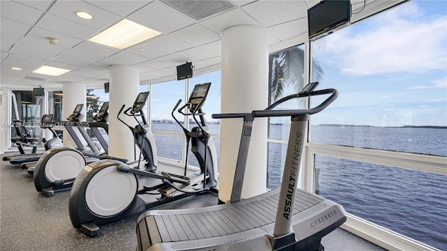 gym with a paneled ceiling and expansive windows