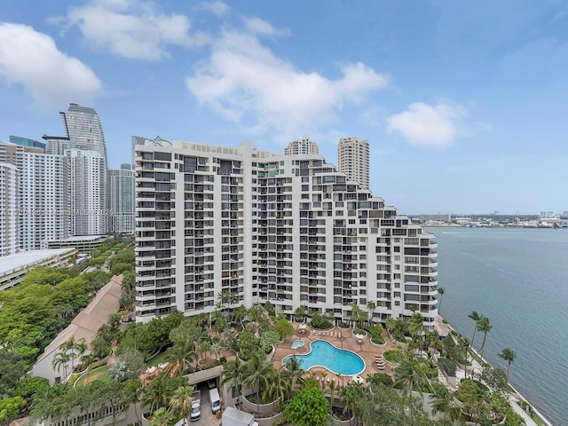 view of property with a water view and a view of city