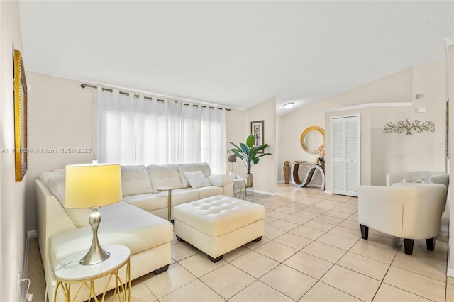 living room featuring vaulted ceiling and light tile patterned flooring