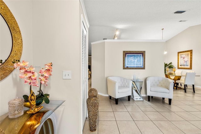 living area featuring light tile patterned floors and lofted ceiling