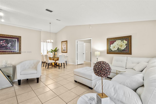 living room featuring light tile patterned flooring, a chandelier, and lofted ceiling