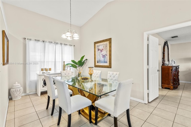 tiled dining space featuring a chandelier and lofted ceiling